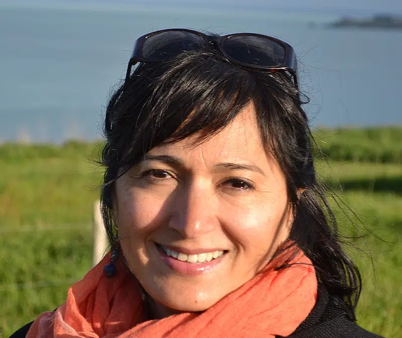 Femme souriante avec écharpe orange en extérieur